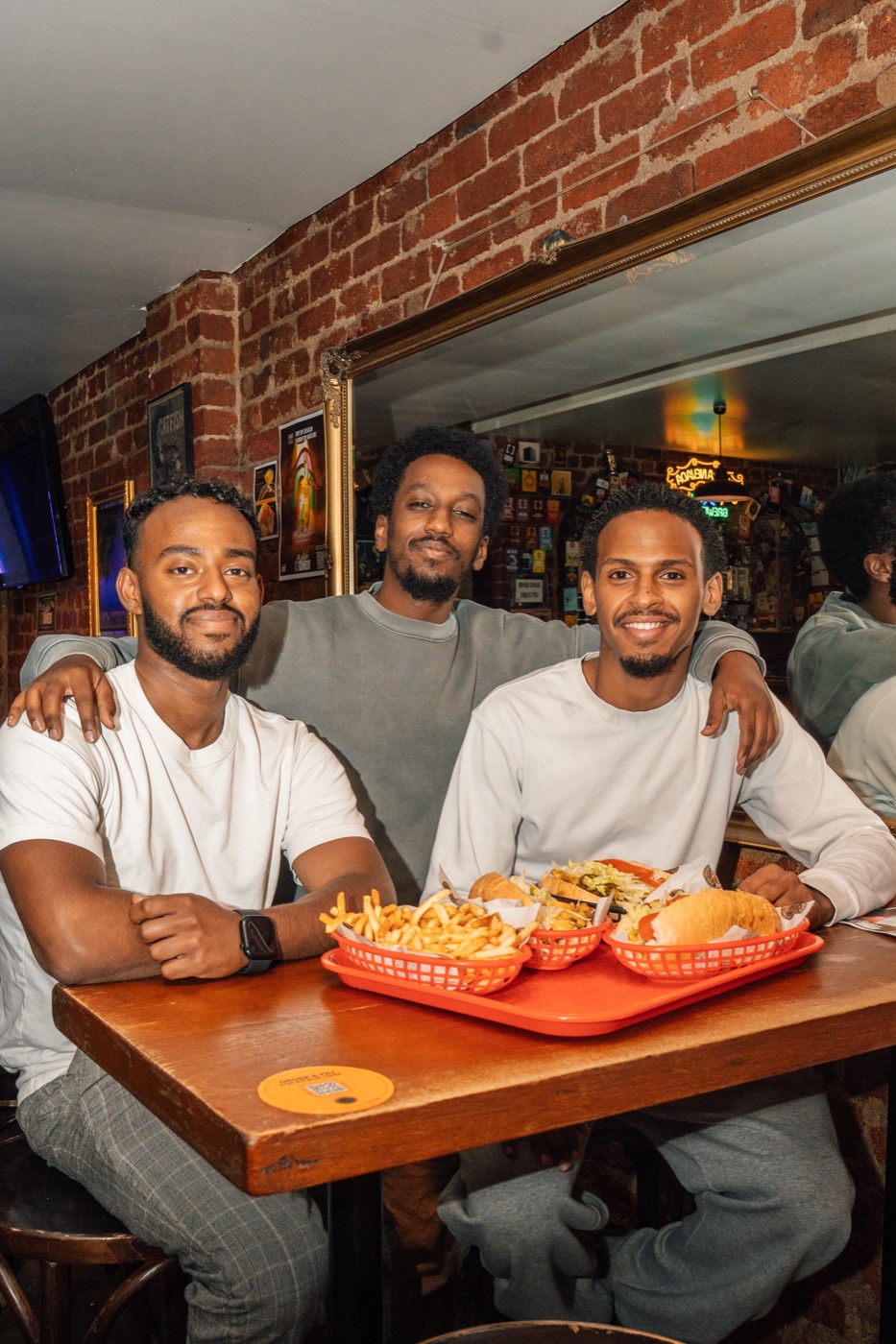 Friends sharing cheesesteaks at Sparrow's Fitzroy