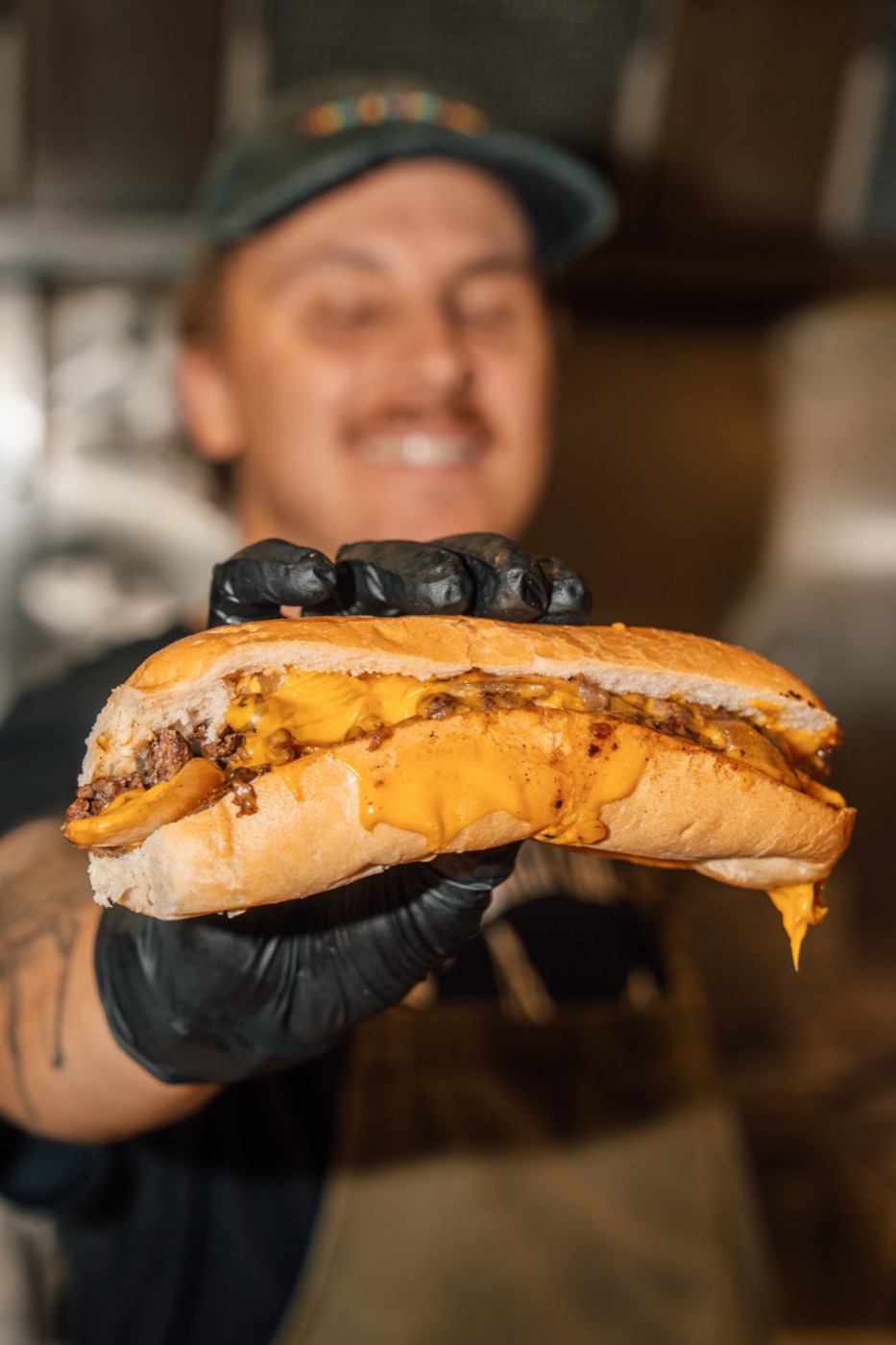 Sparrow's staff holding a fresh cheesesteak