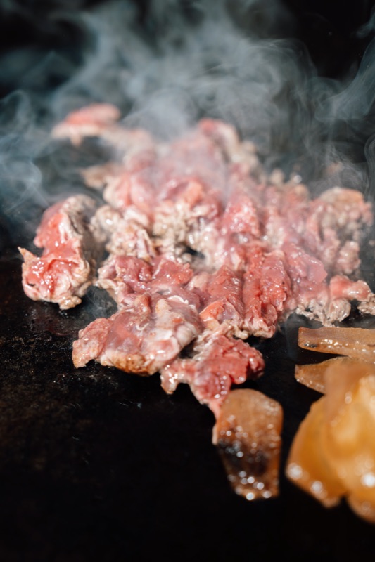 Shaved Grade A steak on the grill